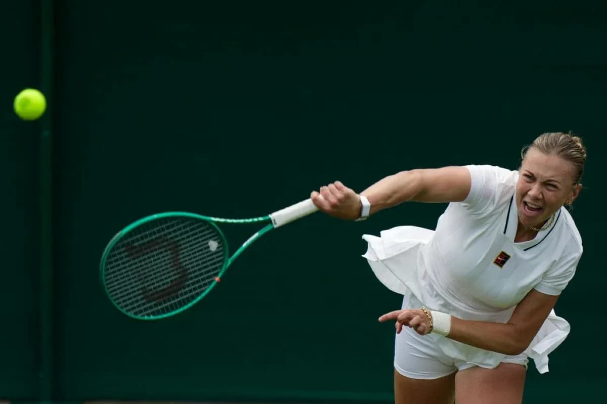Tennis player serving during a match at Wimbledon Tennis player serving during a match at Wimbledon
