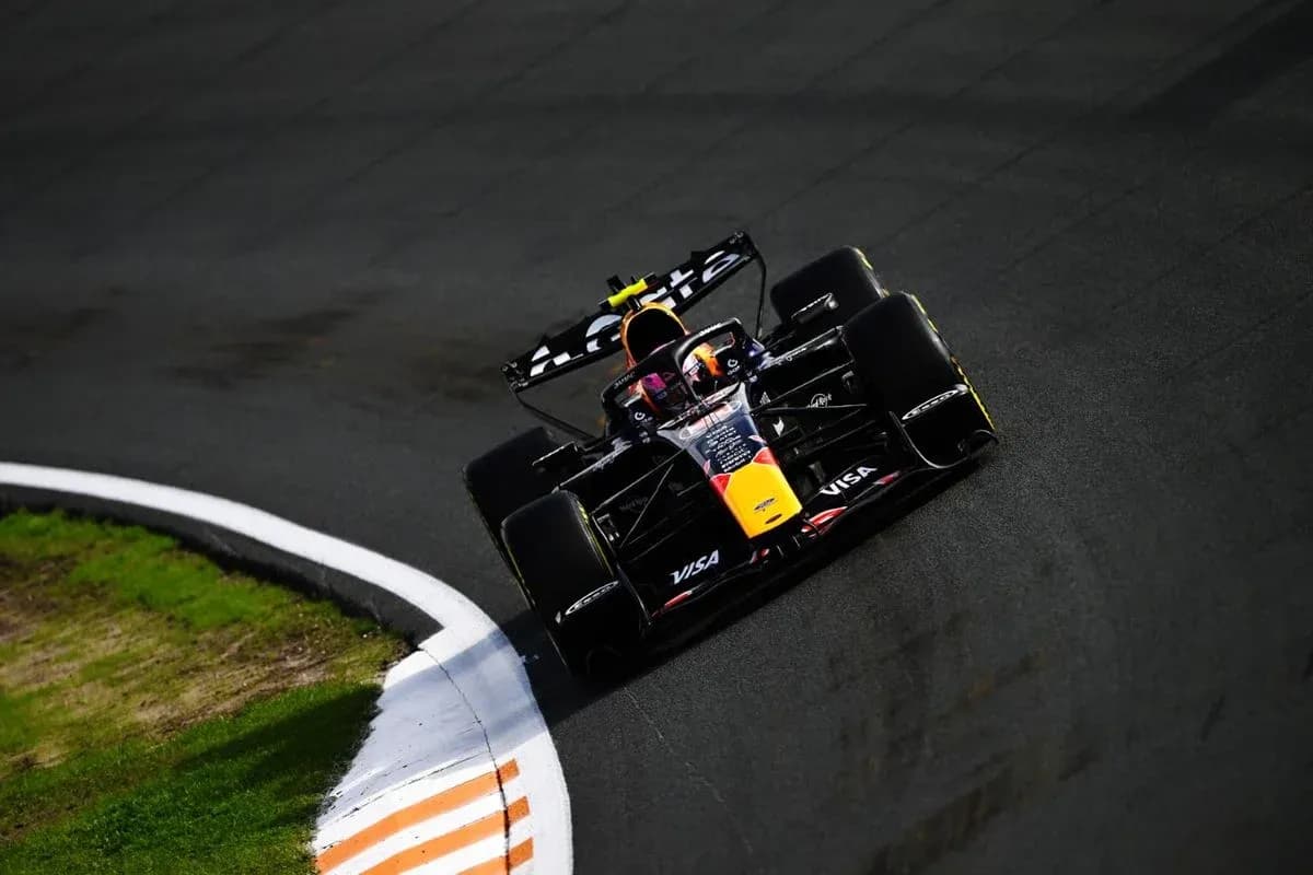 Formula 1 car navigating a curve on track Formula 1 car navigating a curve on track
