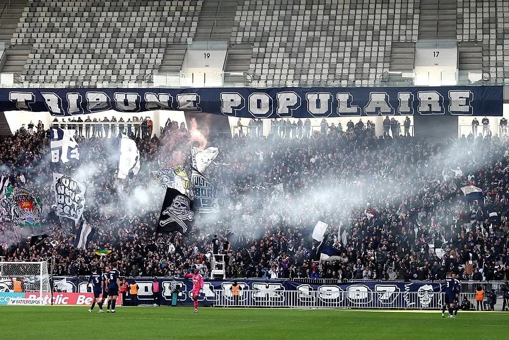 Football fans celebrating with flags and smoke in stadium Football fans celebrating with flags and smoke in stadium