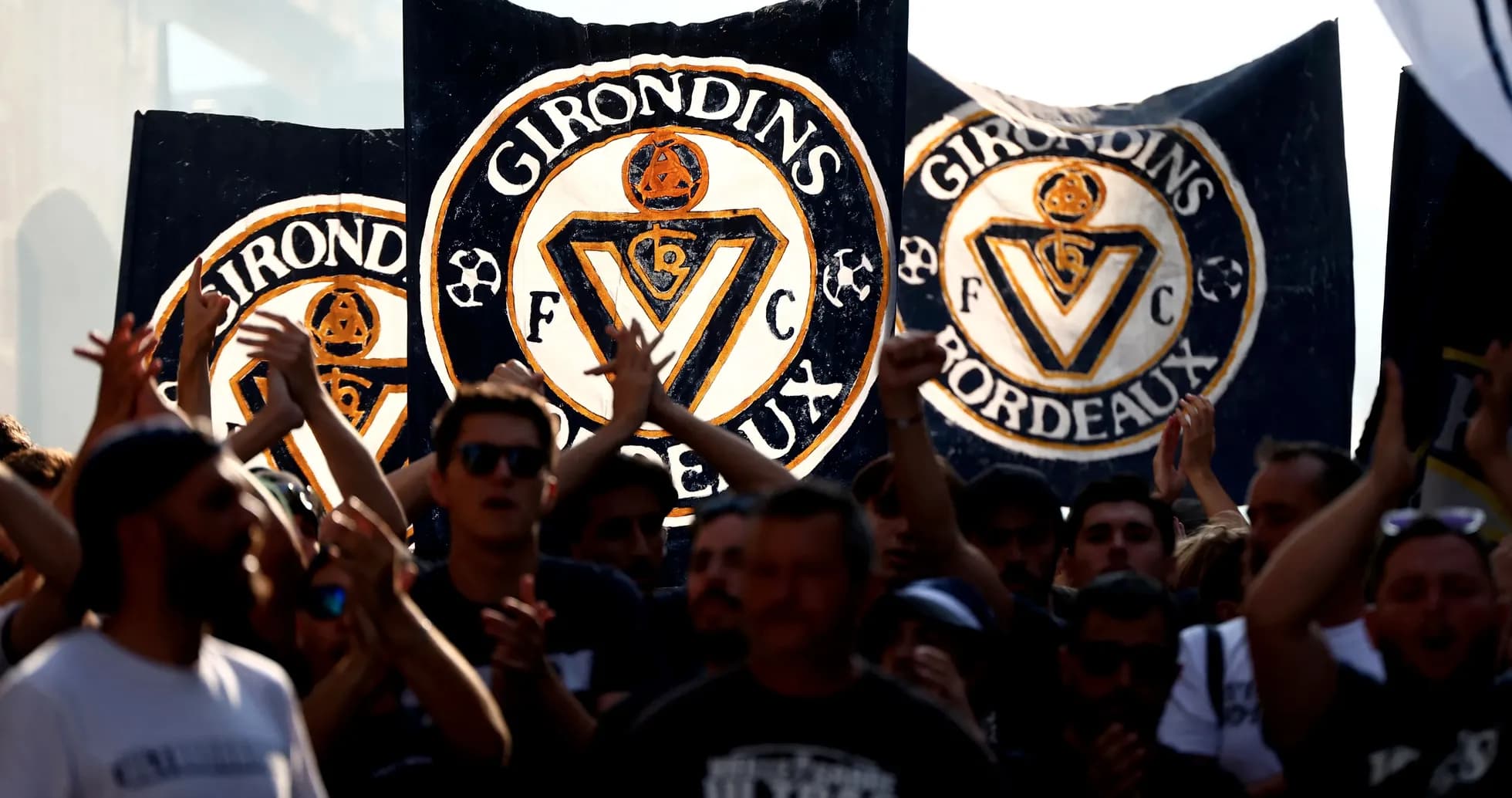 Girondins de Bordeaux fans holding banners and cheering Girondins de Bordeaux fans holding banners and cheering