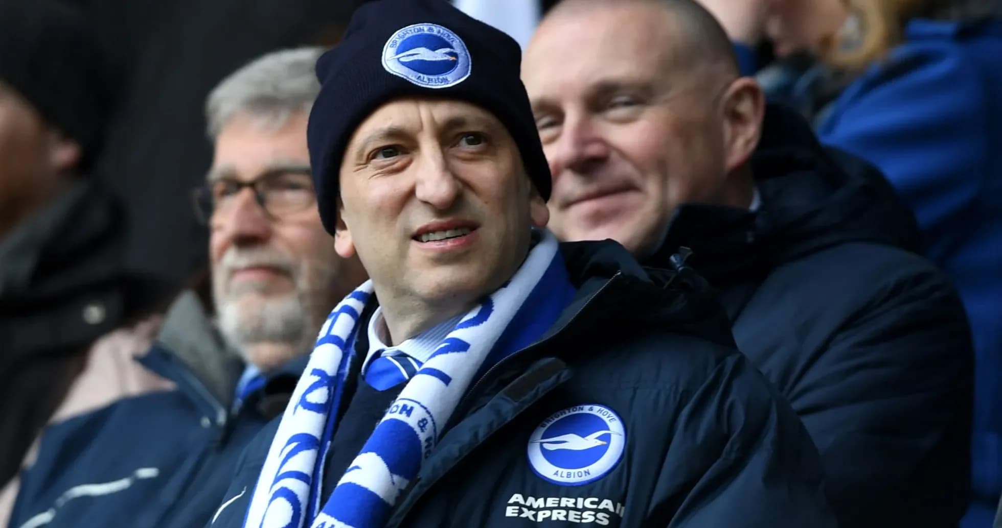 Fans wearing Brighton & Hove Albion merchandise in stadium Fans wearing Brighton & Hove Albion merchandise in stadium