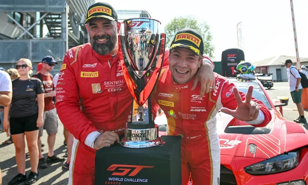 Duo celebrating with trophy after race victory Duo celebrating with trophy after race victory