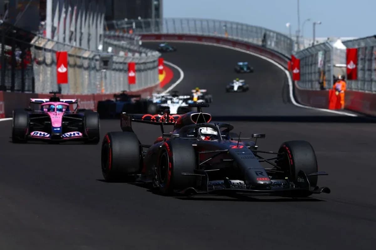 Formula 1 cars racing on a winding circuit Formula 1 cars racing on a winding circuit