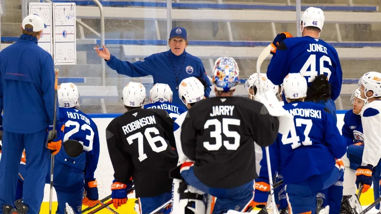 Coach instructing players during hockey practice session Coach instructing players during hockey practice session