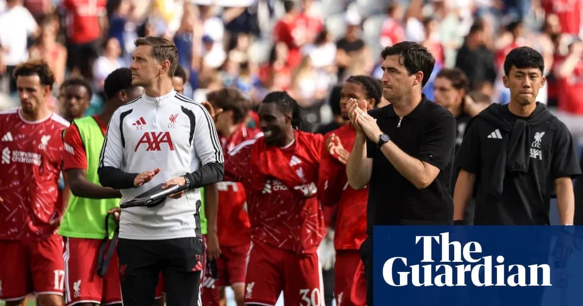 Liverpool players and staff leaving the pitch after match Liverpool players and staff leaving the pitch after match