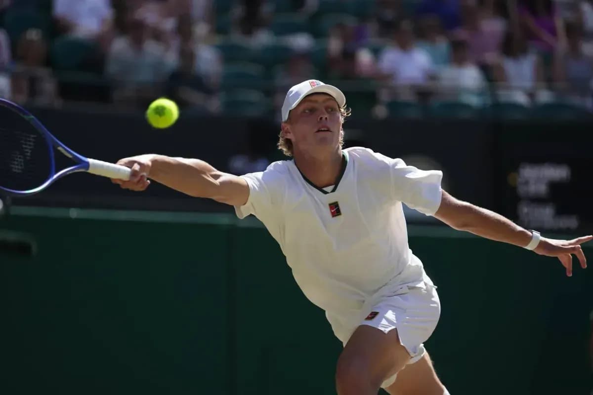 Tennis player reaching for a flying ball Tennis player reaching for a flying ball