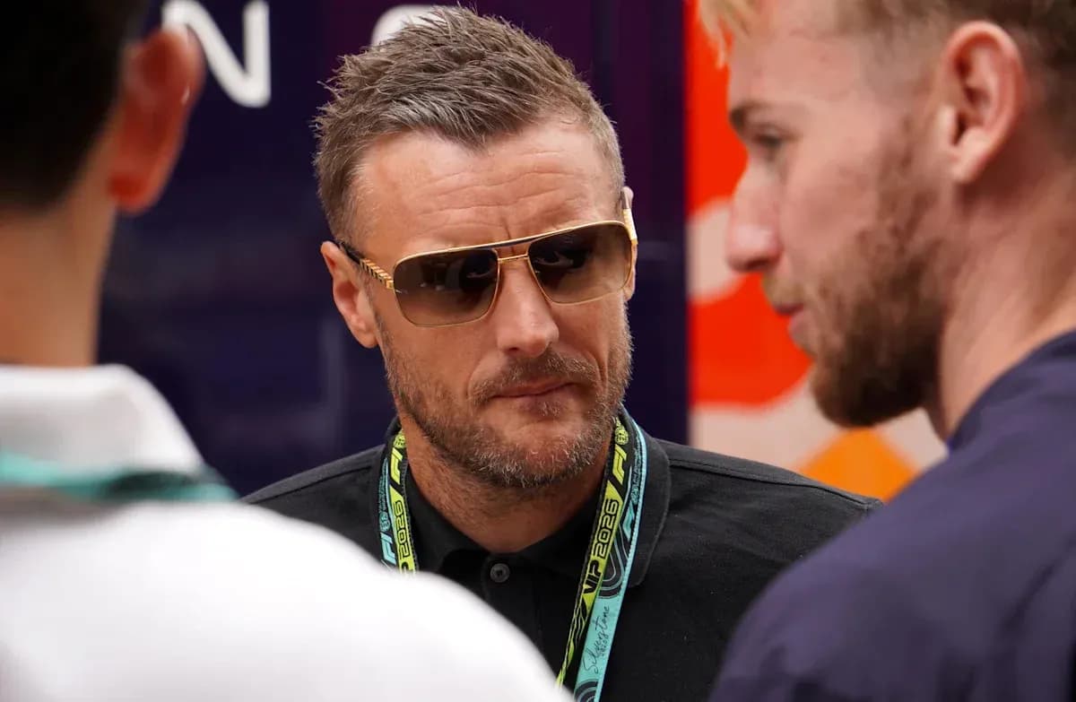 Man in sunglasses conversing with two others Man in sunglasses conversing with two others