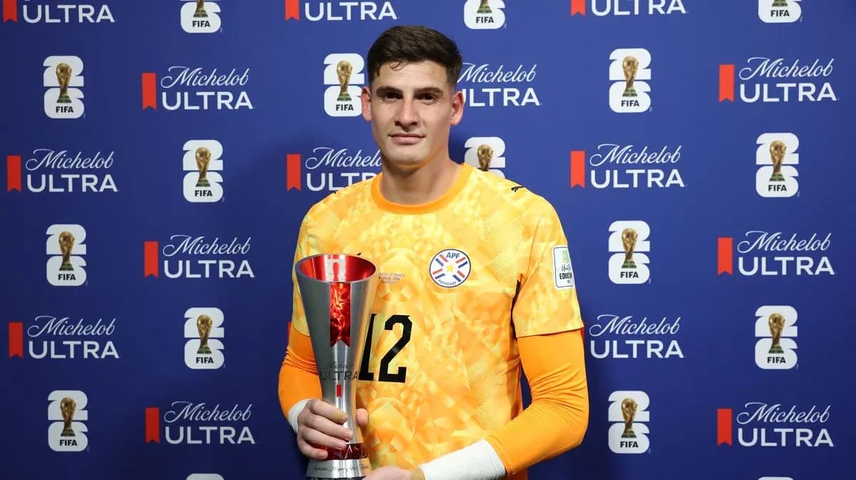Goalkeeper holding trophy in front of sponsor backdrop Goalkeeper holding trophy in front of sponsor backdrop