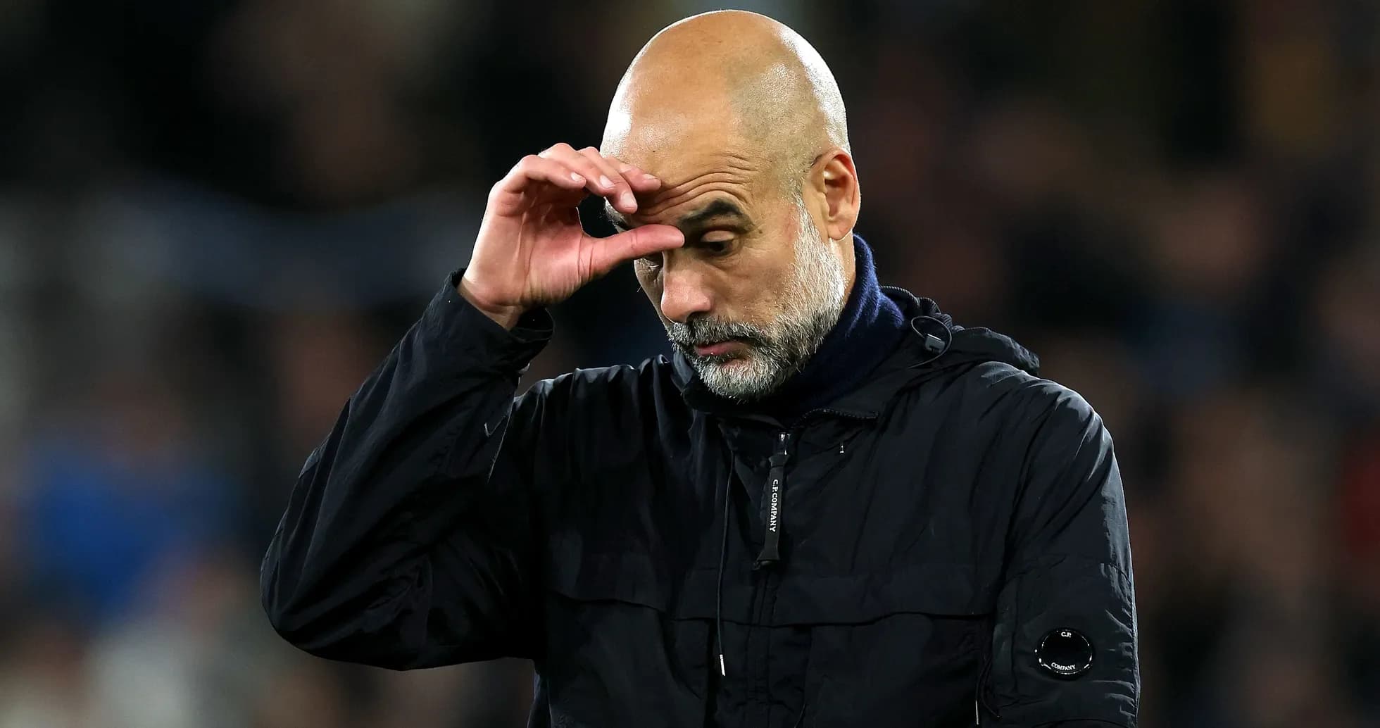 Football manager looking down during match Football manager looking down during match