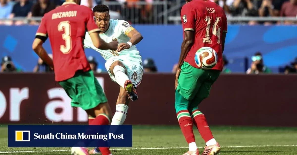 Player kicking ball while defenders attempt to block Player kicking ball while defenders attempt to block