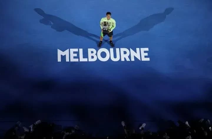 Tennis player holding trophy on Melbourne court Tennis player holding trophy on Melbourne court