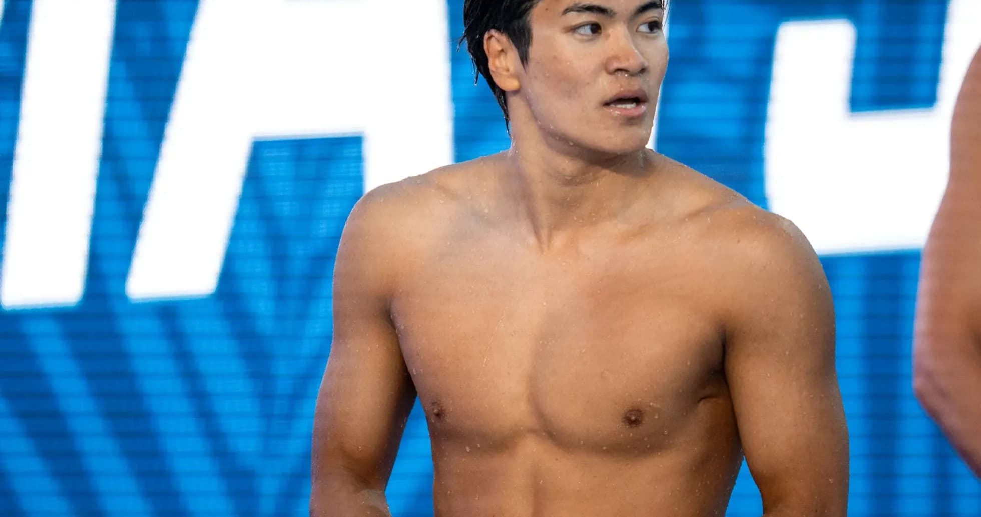 Yoshida standing on poolside before competition Yoshida standing on poolside before competition
