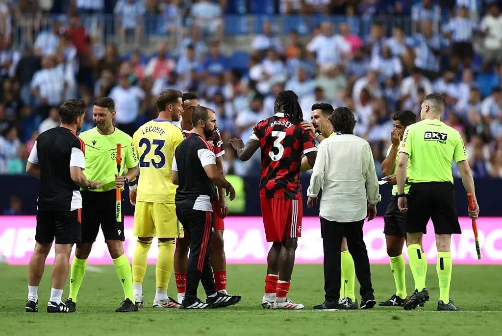 Players and officials discussing on the pitch Players and officials discussing on the pitch