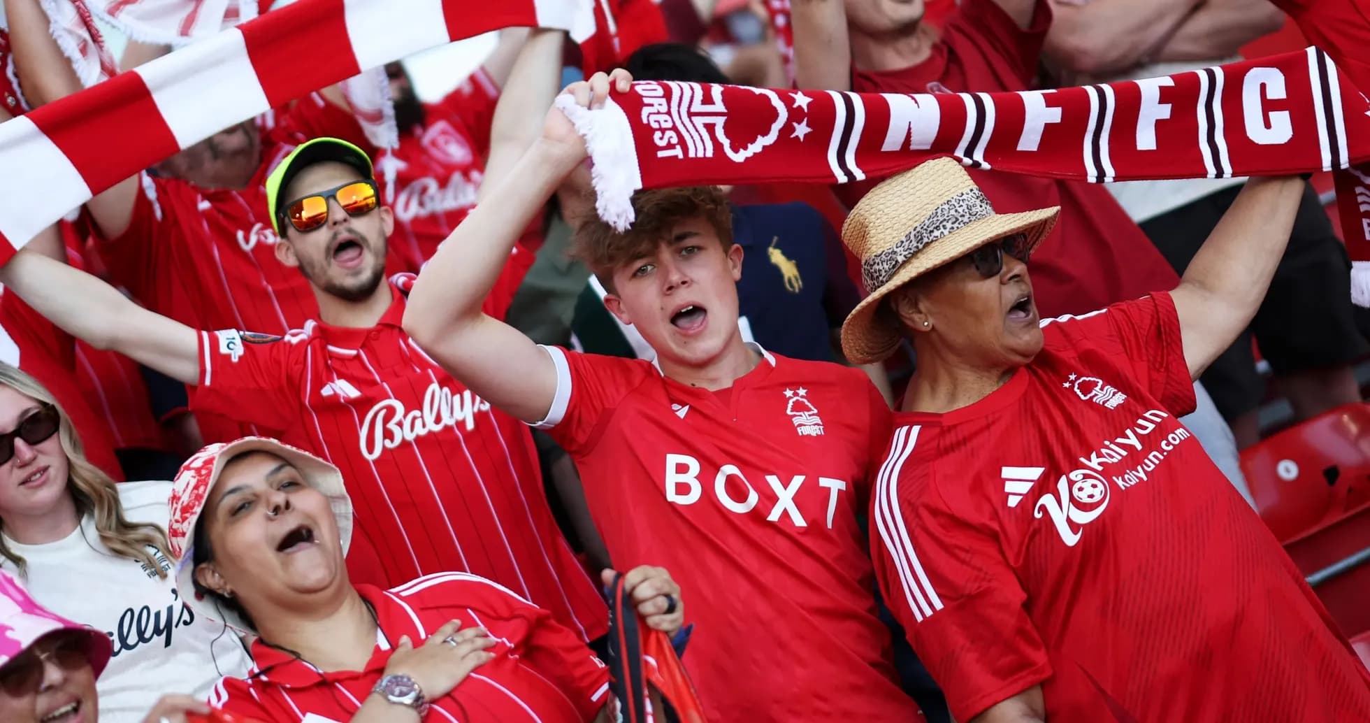 Fans celebrating and cheering in Nottingham Forest jerseys Fans celebrating and cheering in Nottingham Forest jerseys