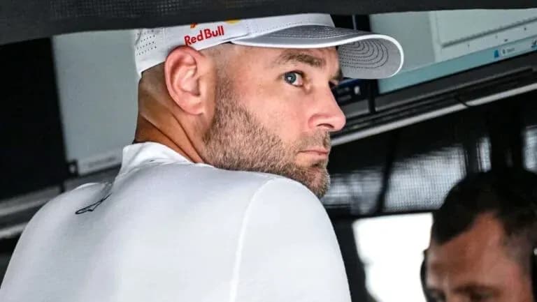 Man in Red Bull cap looking towards screen Man in Red Bull cap looking towards screen