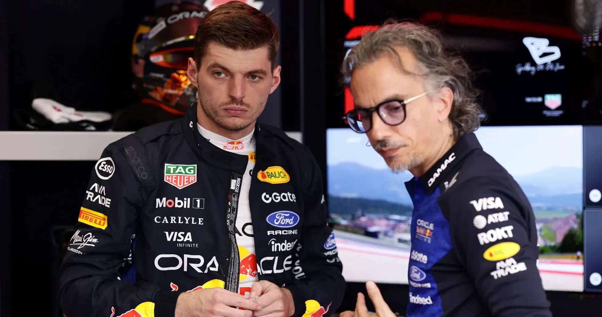 Max Verstappen discussing with team engineer in garage Max Verstappen discussing with team engineer in garage