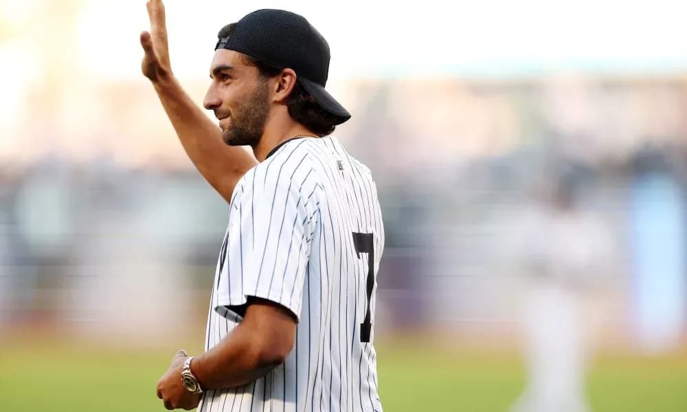 Man waving while wearing baseball jersey at stadium Man waving while wearing baseball jersey at stadium