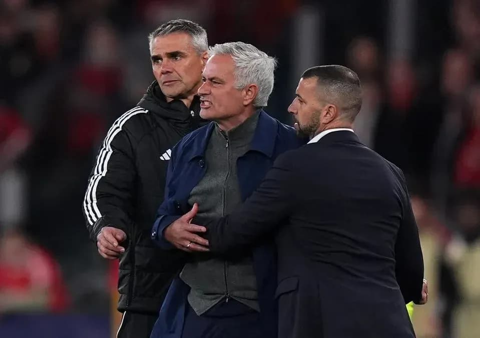 Mourinho being restrained by staff during match Mourinho being restrained by staff during match