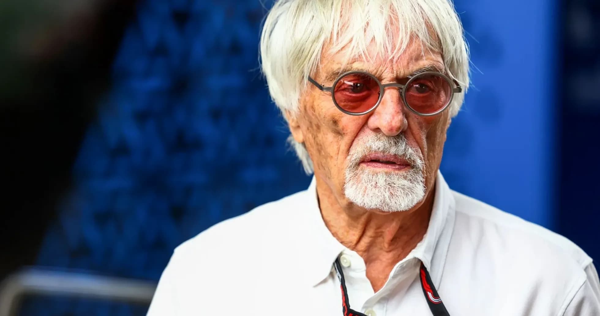 Man with white hair and sunglasses in casual attire Man with white hair and sunglasses in casual attire