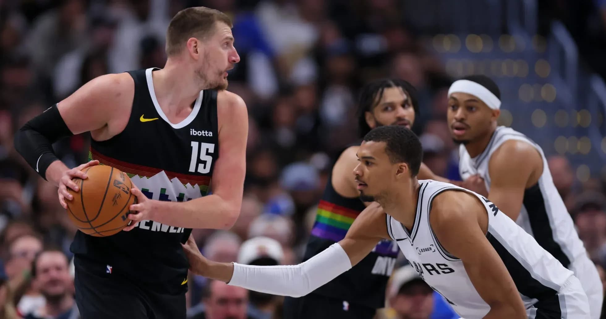 Nikola Jokic dribbling the ball during game action Nikola Jokic dribbling the ball during game action