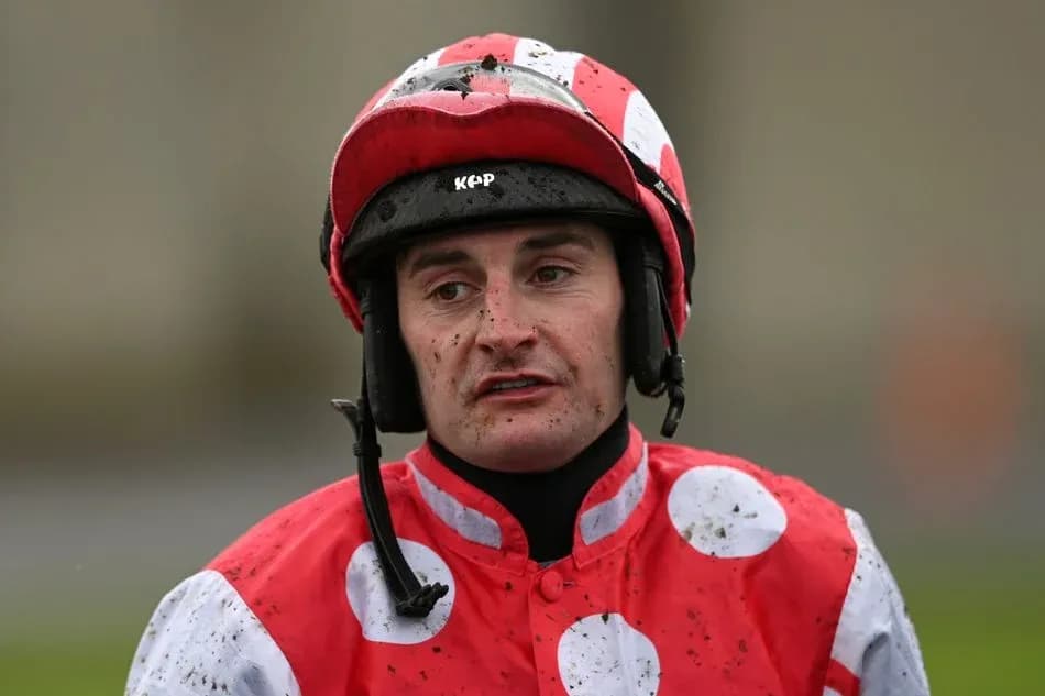 Jockey wearing red and white silks after race Jockey wearing red and white silks after race