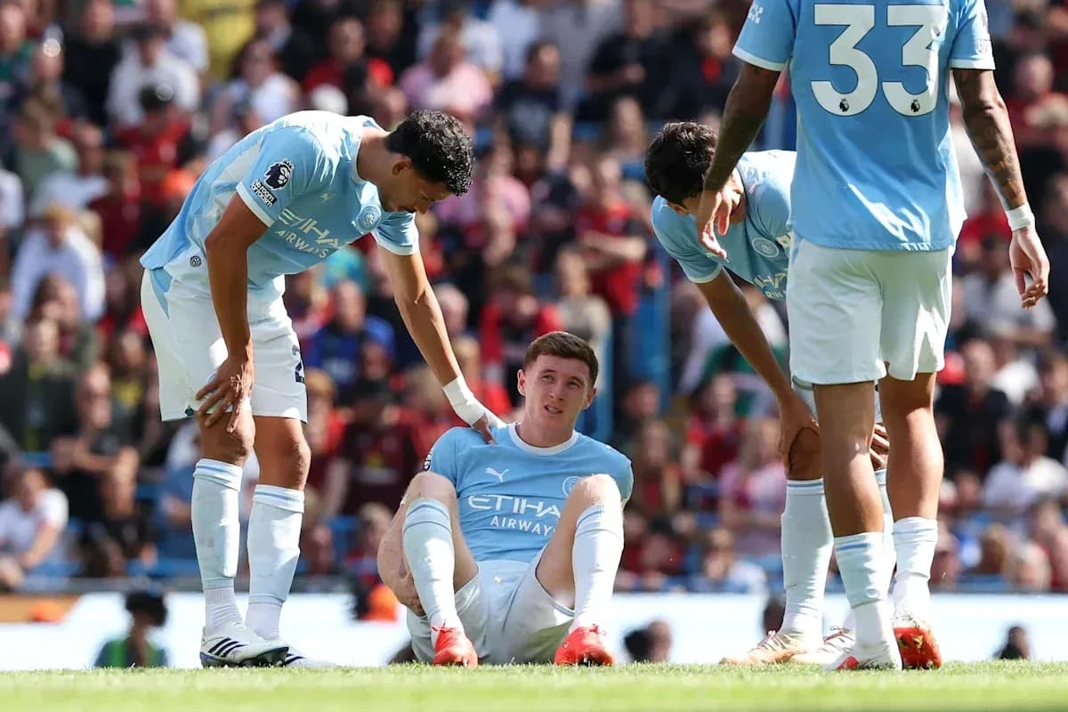 Manchester City players assisting injured teammate on pitch Manchester City players assisting injured teammate on pitch