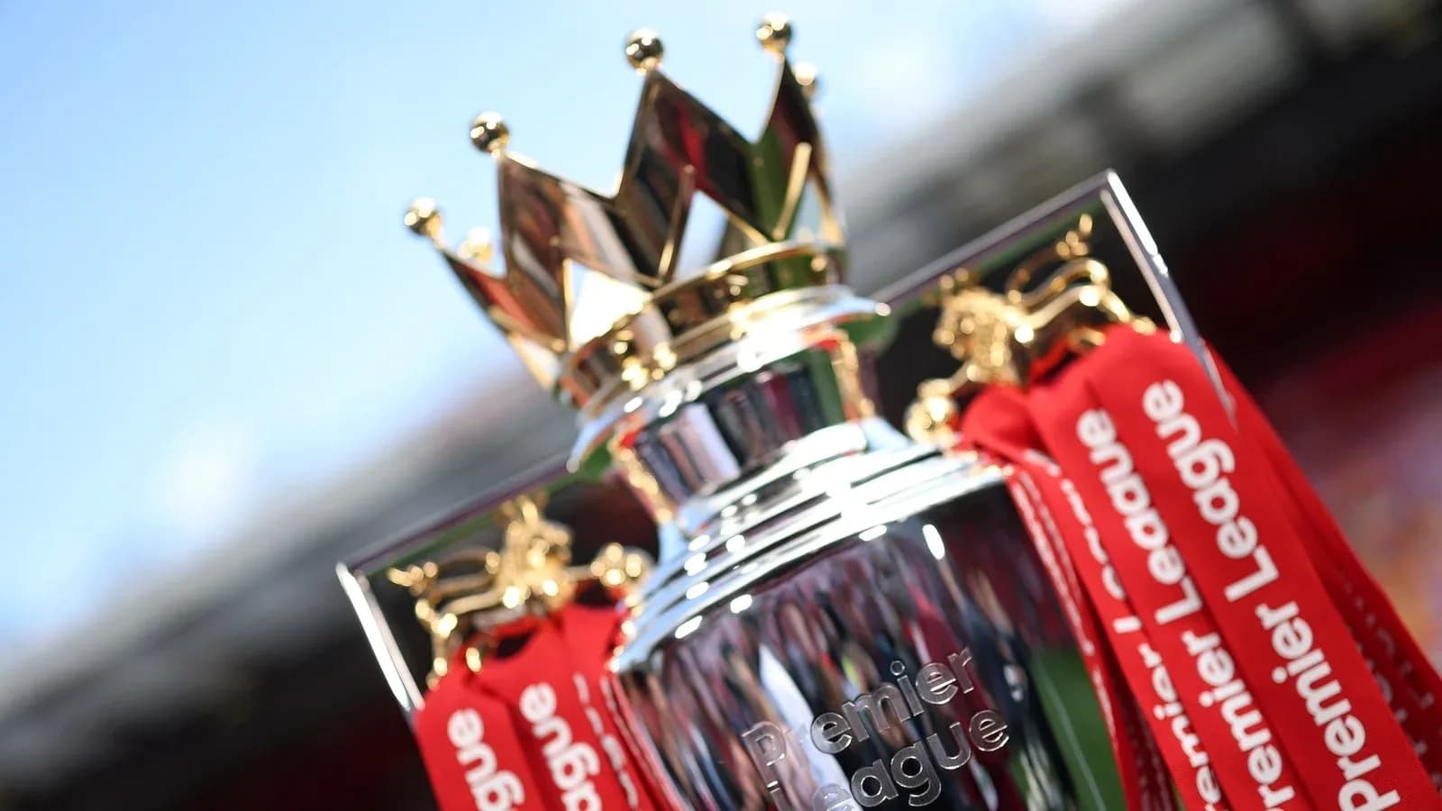 Premier League trophy with red ribbons displayed Premier League trophy with red ribbons displayed