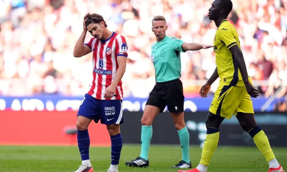 Atletico Madrid player reacting during match with referee Atletico Madrid player reacting during match with referee