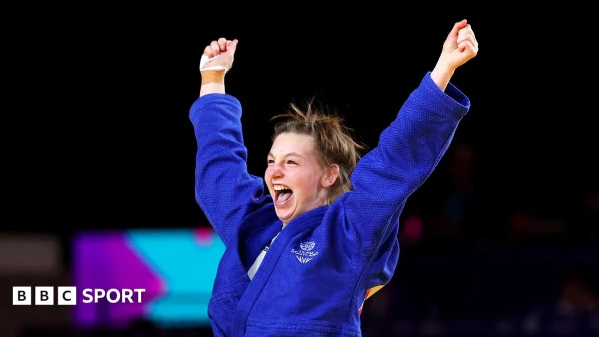 Judoka celebrating victory with raised arms Judoka celebrating victory with raised arms