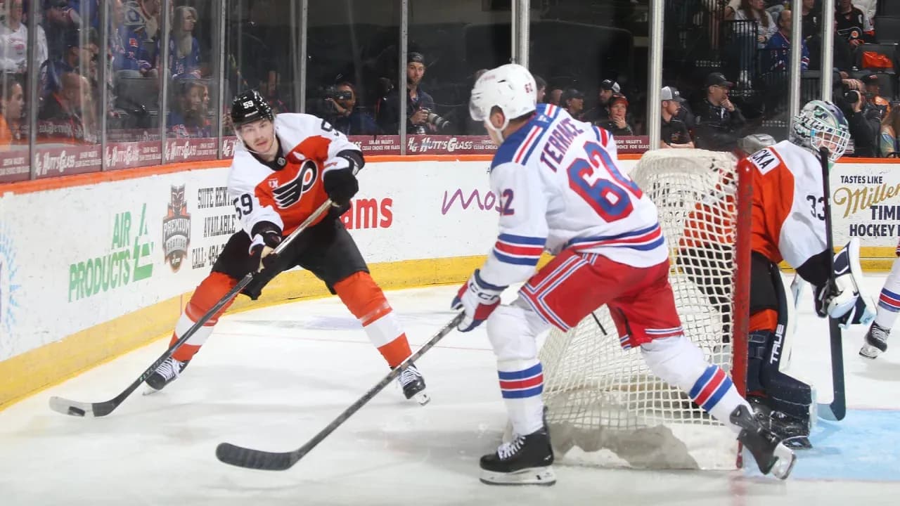 Flyers player skating with puck near goal Flyers player skating with puck near goal