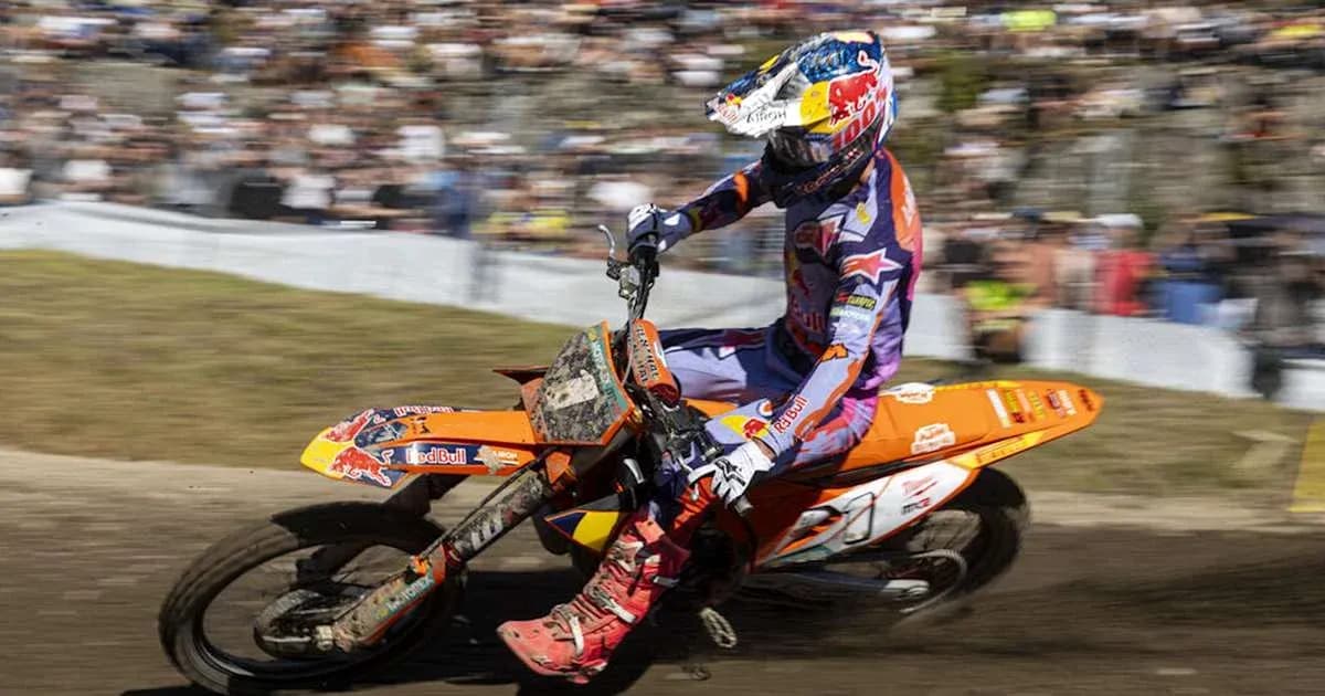 Motocross rider navigating a turn on dirt track Motocross rider navigating a turn on dirt track