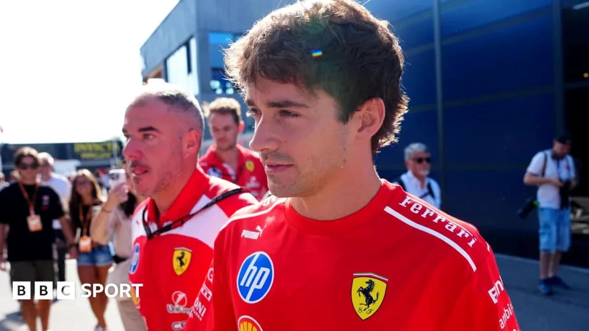Ferrari team members walking in the paddock area Ferrari team members walking in the paddock area