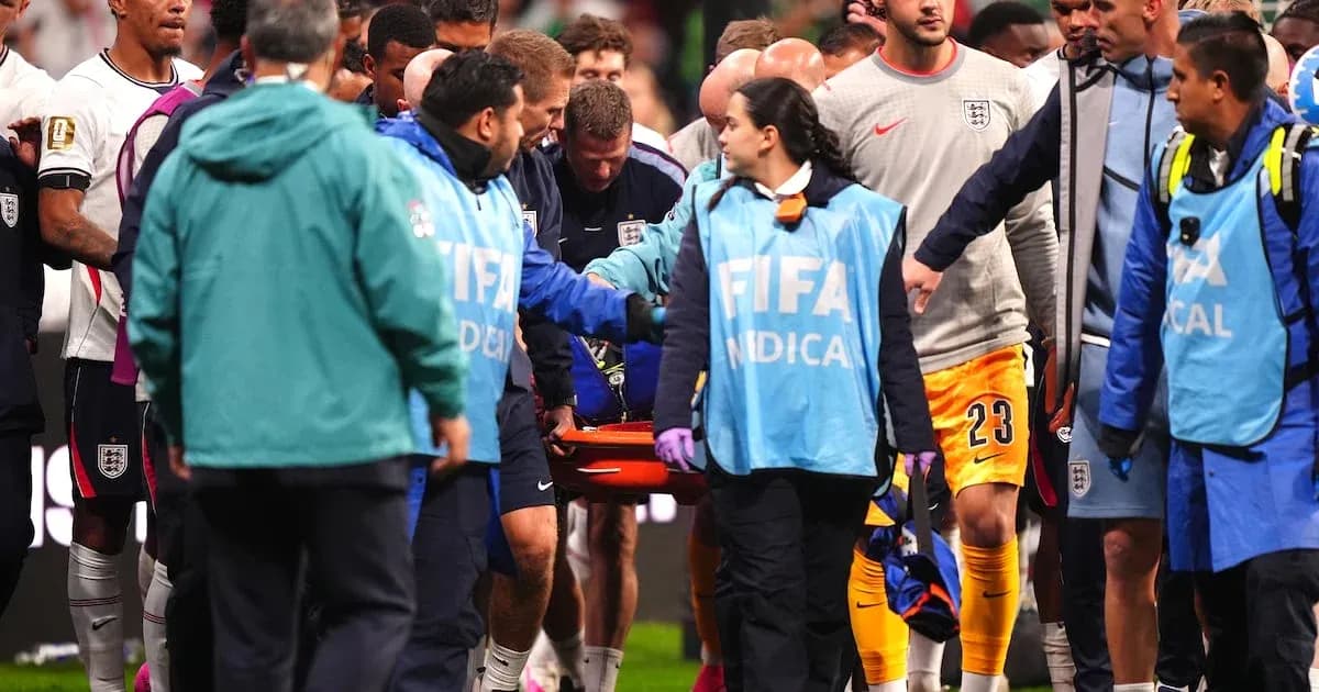 Medical team assisting injured player off the field Medical team assisting injured player off the field