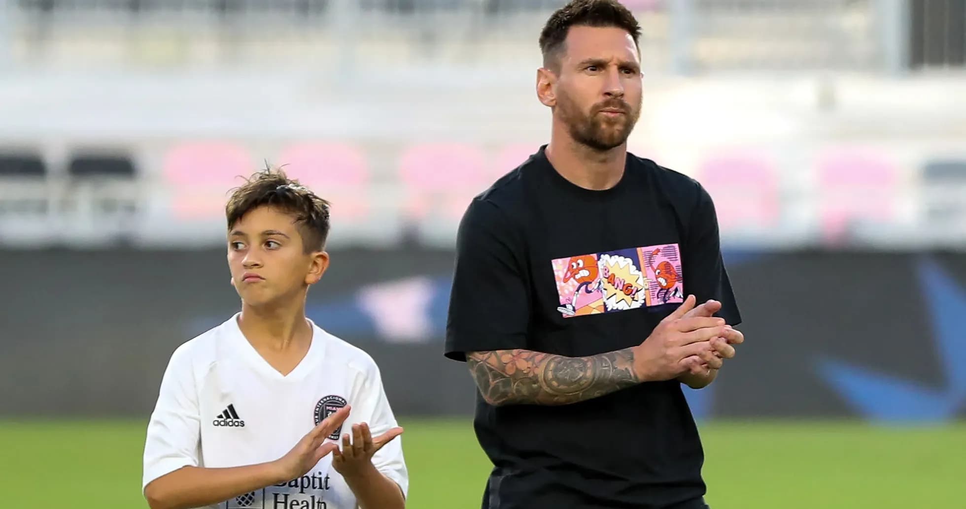 Lionel Messi and child clapping on the field Lionel Messi and child clapping on the field