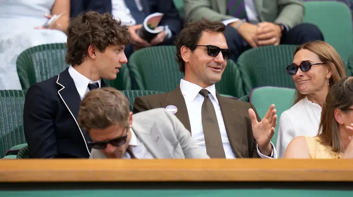 People seated at Wimbledon, engaging in conversation People seated at Wimbledon, engaging in conversation