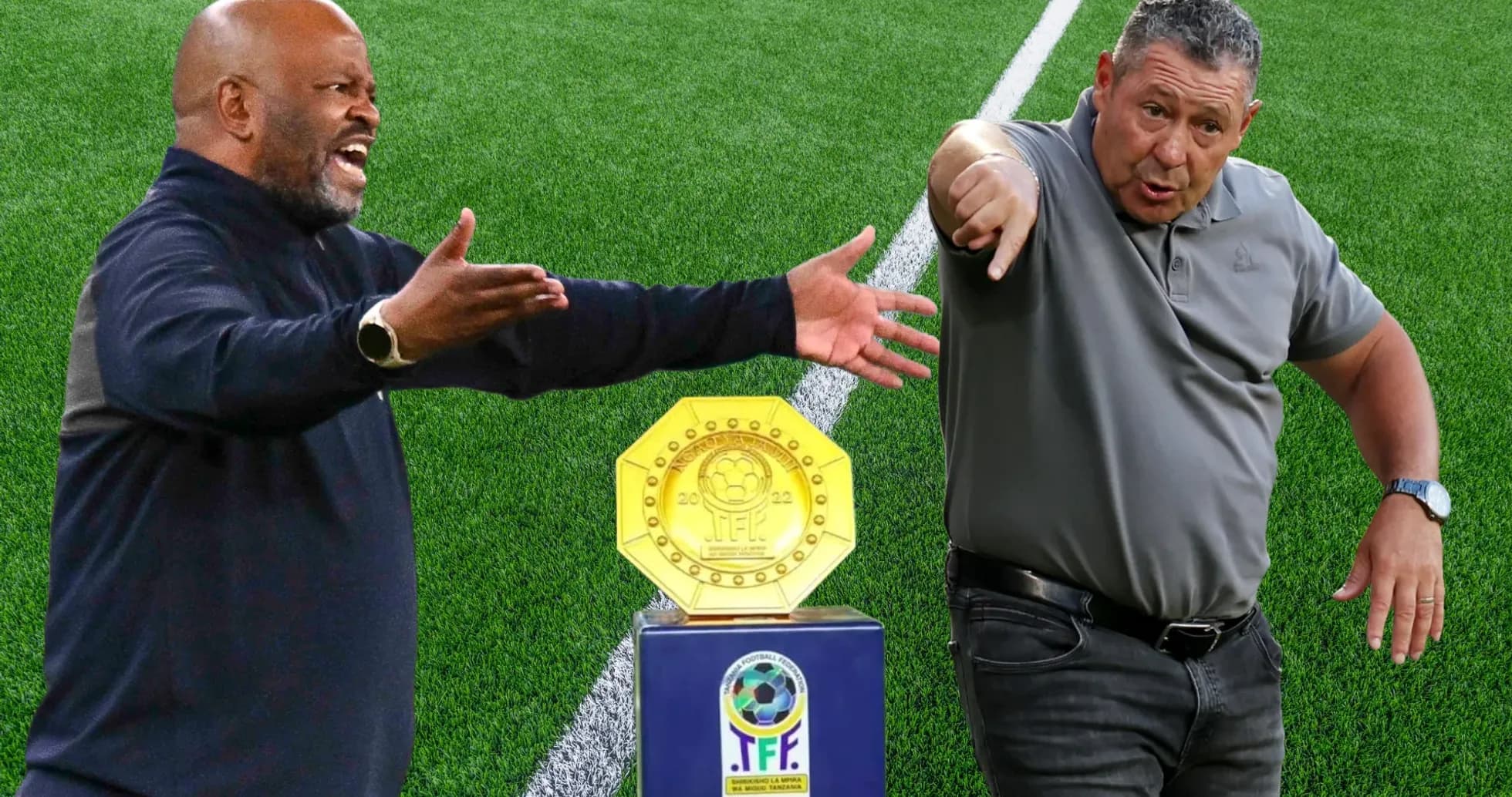 Two coaches gesturing beside a trophy on field Two coaches gesturing beside a trophy on field