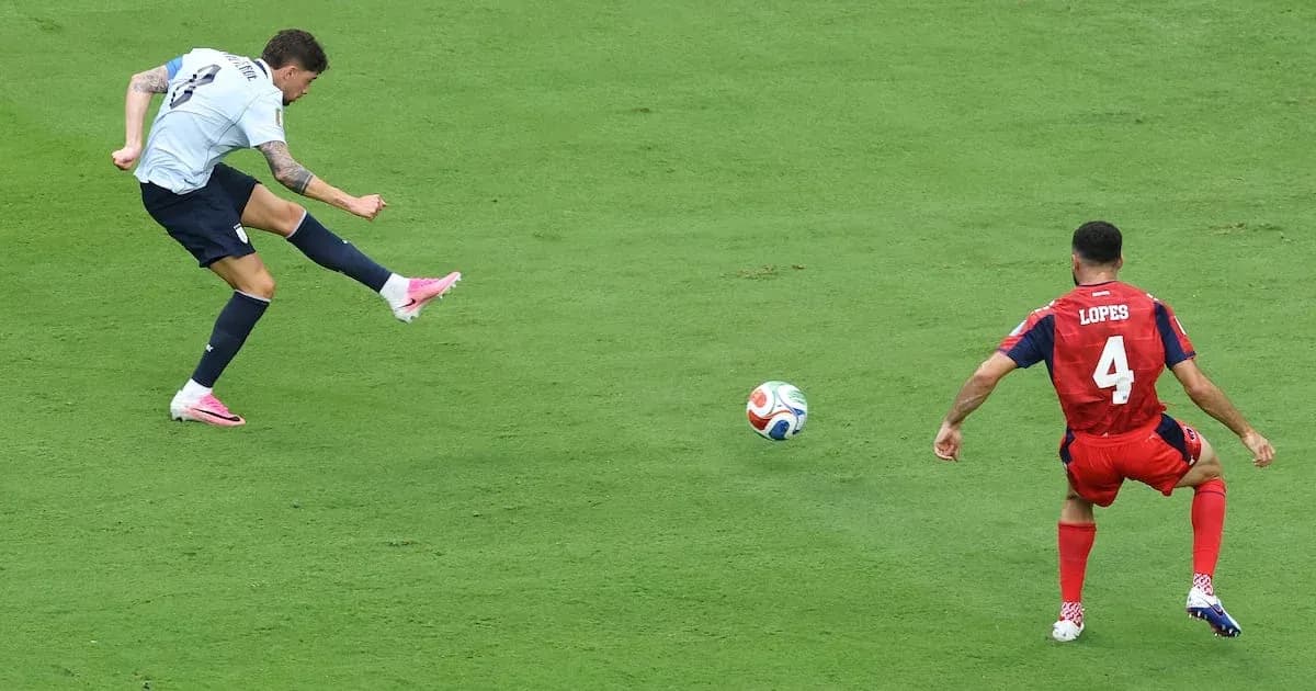 Player kicking ball while opponent defends during match Player kicking ball while opponent defends during match