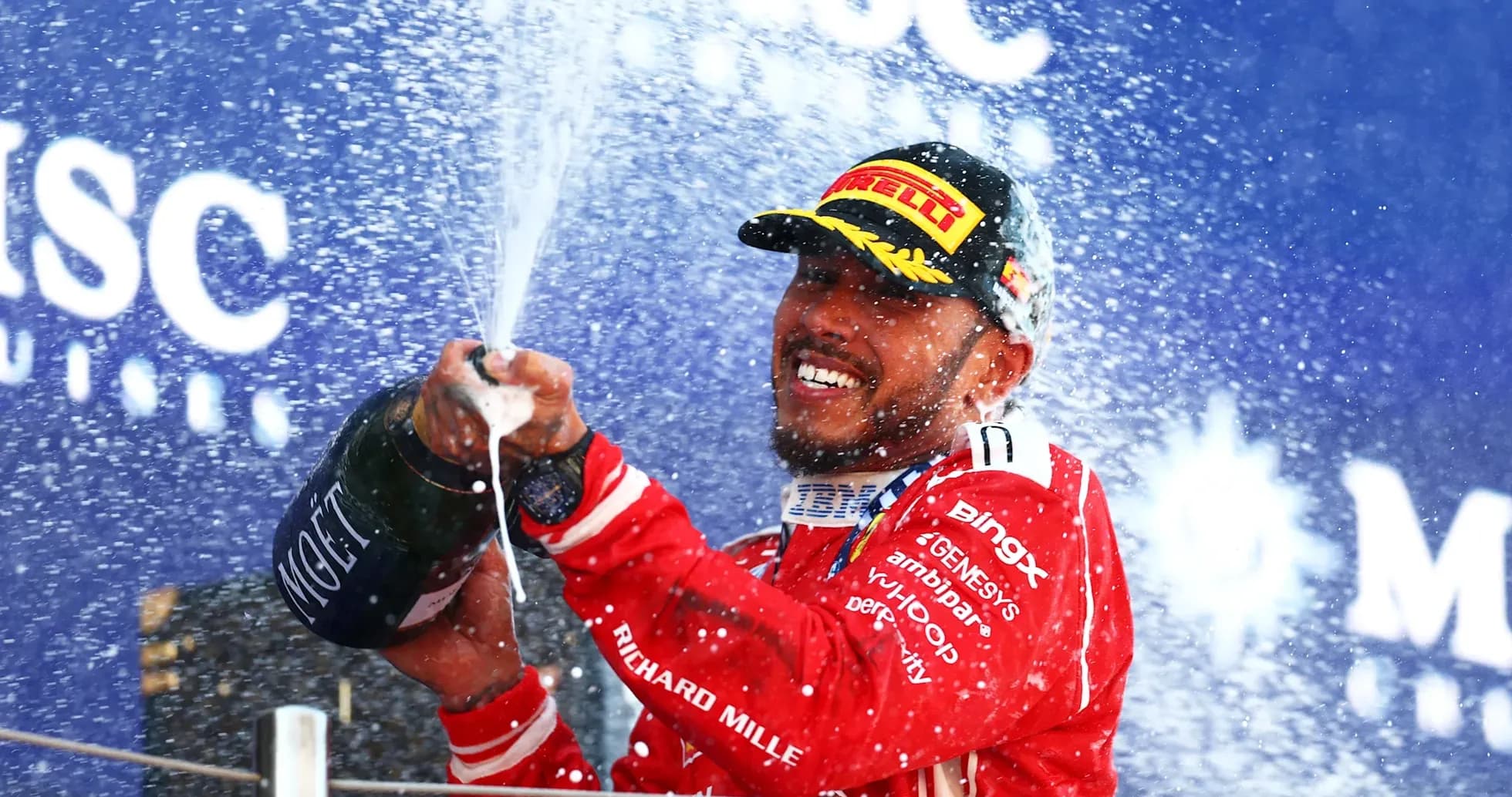 Driver celebrating with champagne on podium Driver celebrating with champagne on podium