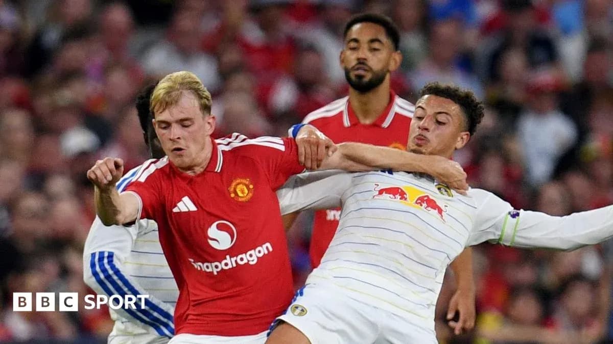 Manchester United player battling Leeds United opponent Manchester United player battling Leeds United opponent