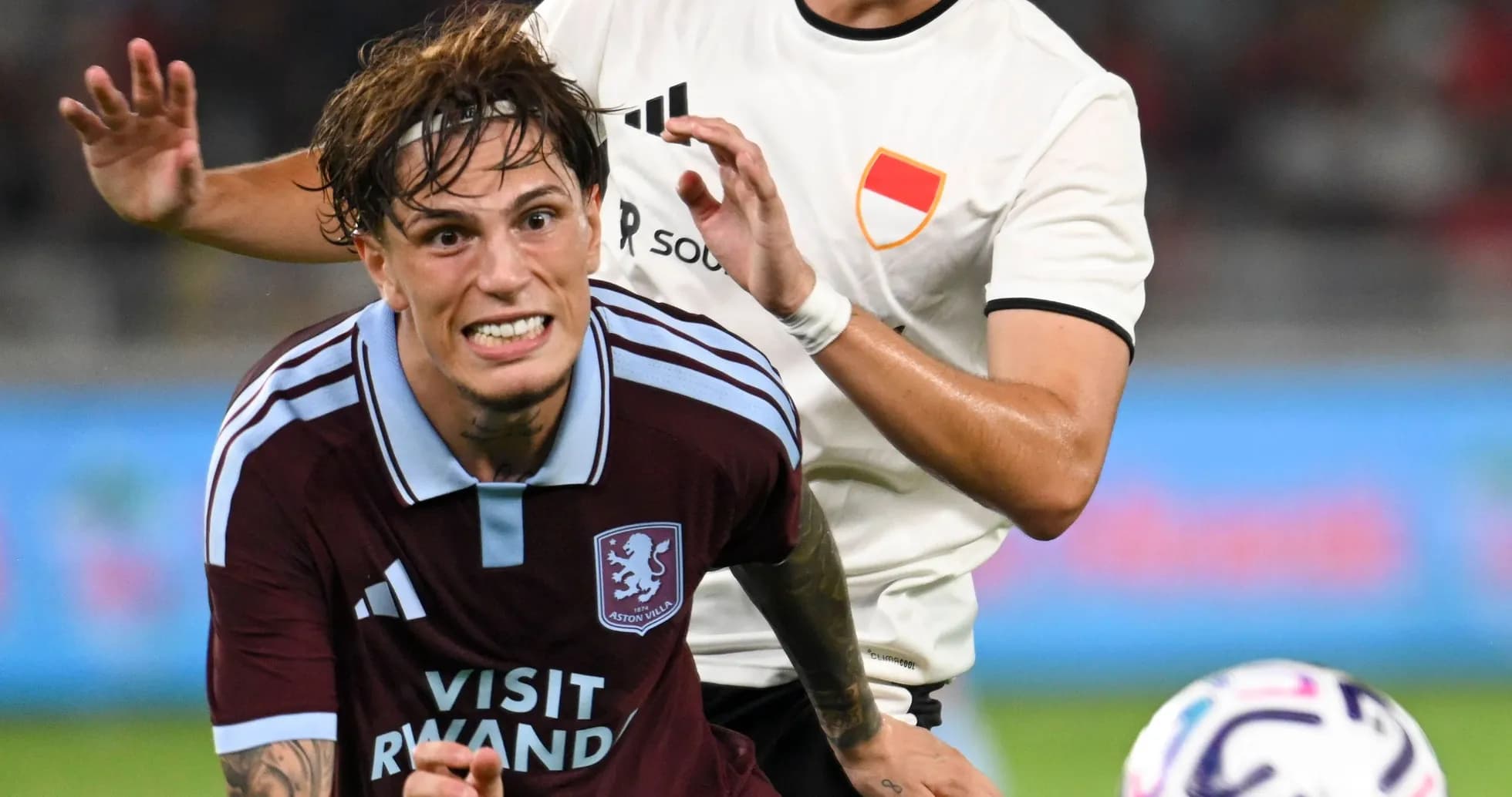 Aston Villa player being challenged during match Aston Villa player being challenged during match