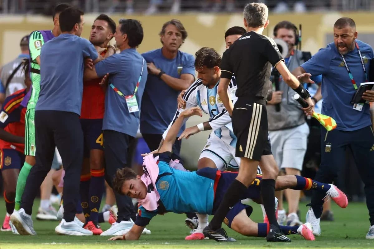 Players and staff involved in a scuffle on the pitch Players and staff involved in a scuffle on the pitch