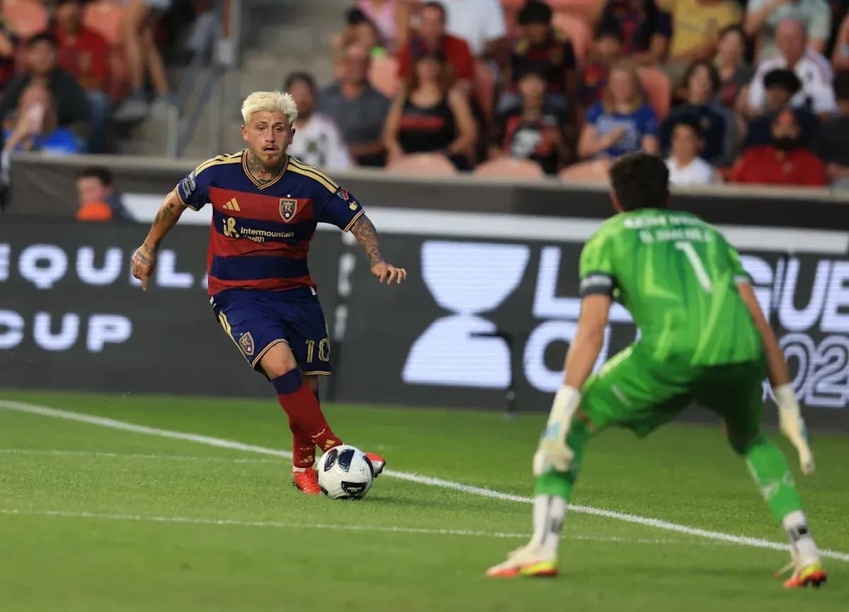 Player dribbling towards goalkeeper during match Player dribbling towards goalkeeper during match