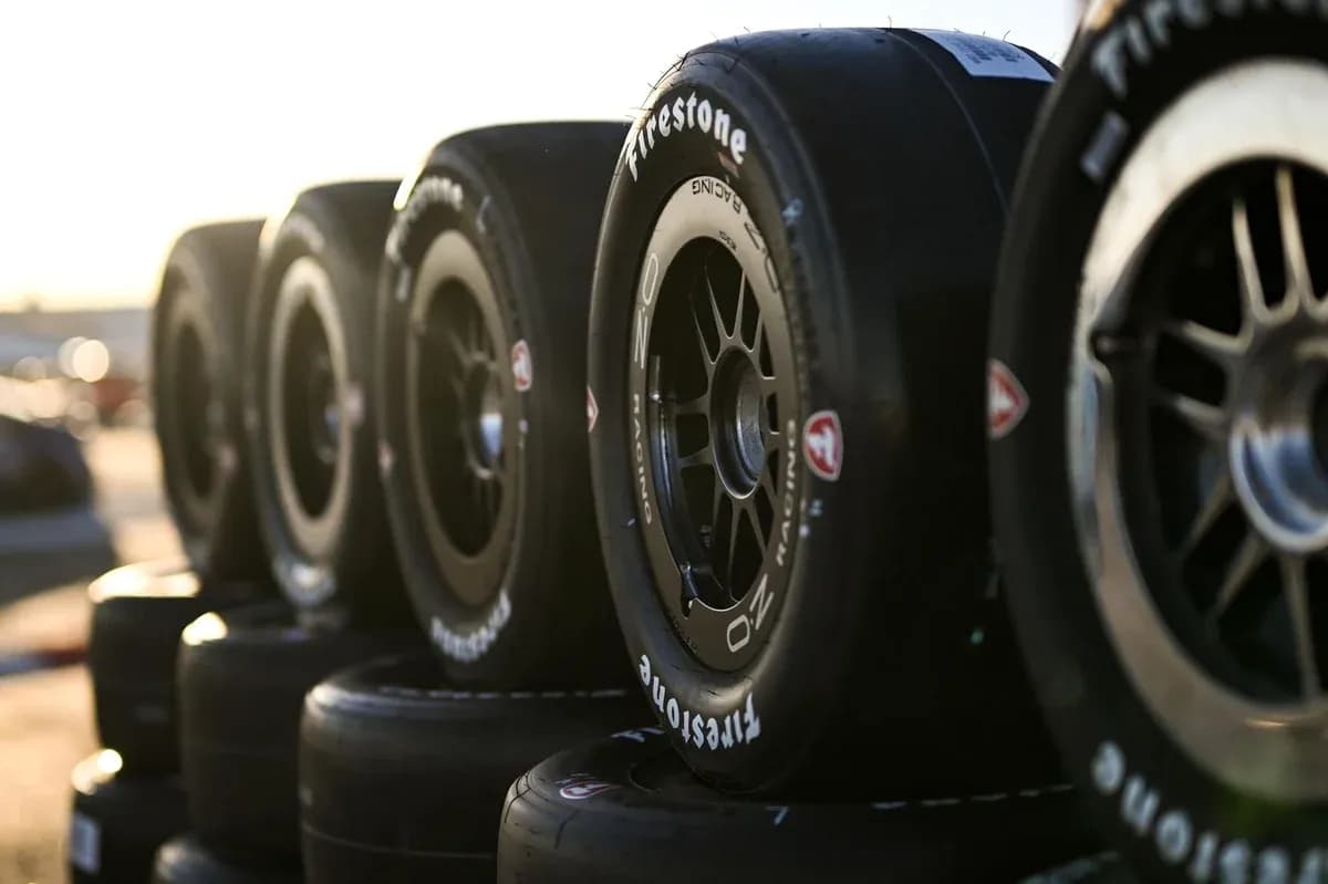 Firestone racing tires stacked in sunlight Firestone racing tires stacked in sunlight