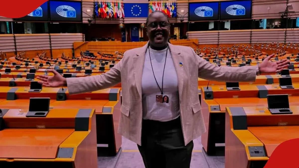 Woman standing in empty parliamentary chamber with arms open Woman standing in empty parliamentary chamber with arms open