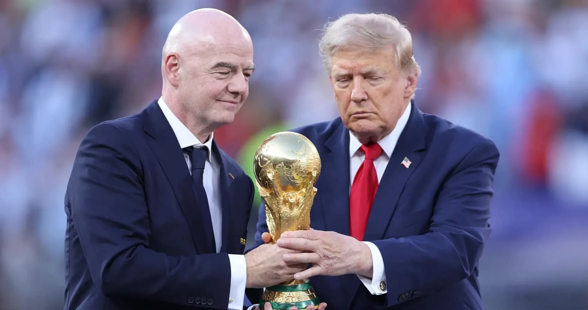 Two men holding the FIFA World Cup trophy Two men holding the FIFA World Cup trophy