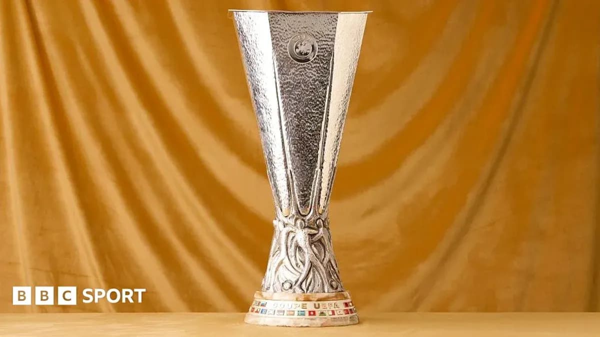 UEFA Europa League trophy on golden backdrop UEFA Europa League trophy on golden backdrop