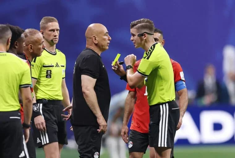 Referee discussing with team officials during match Referee discussing with team officials during match