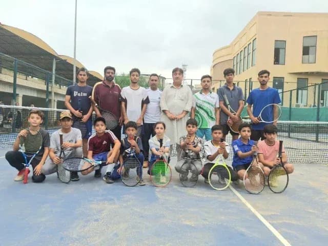 Tennis players posing together on court Tennis players posing together on court
