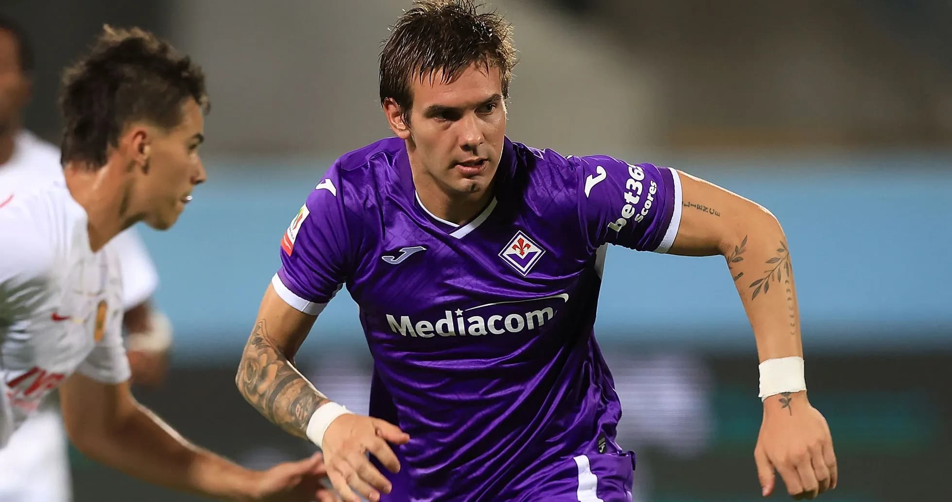 Fiorentina player dribbling the ball during match Fiorentina player dribbling the ball during match