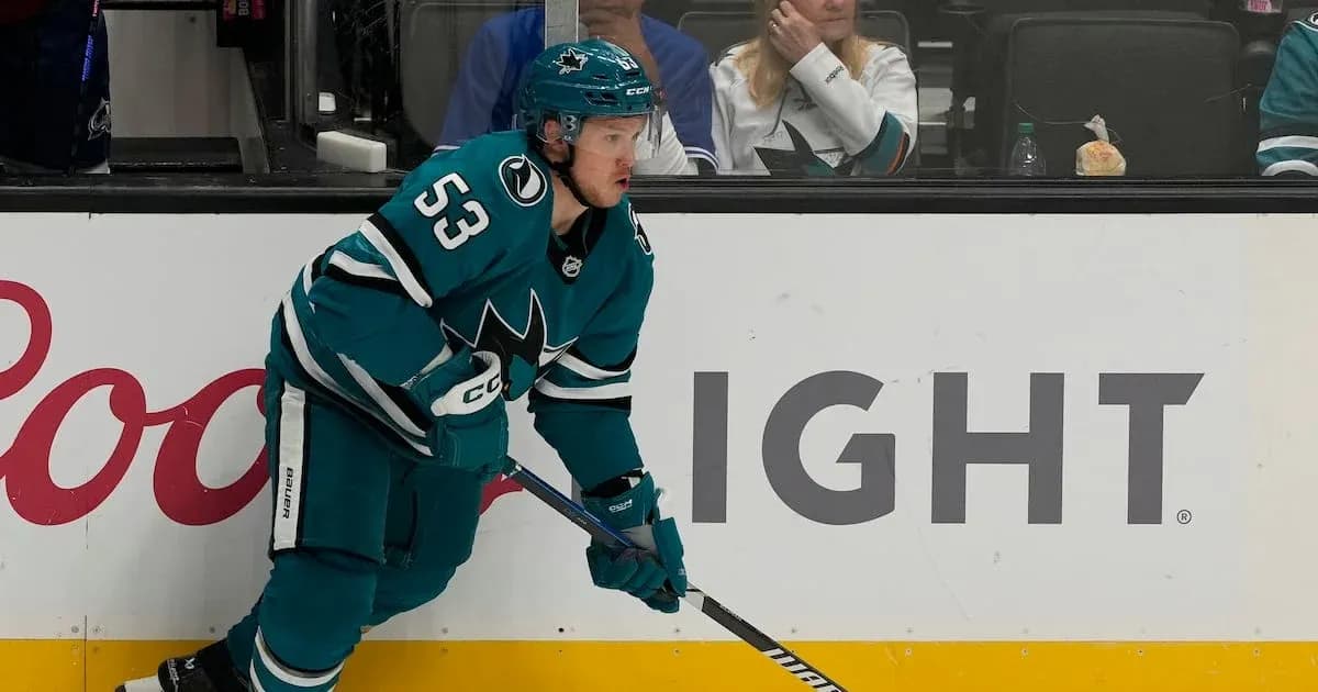 Hockey player in teal uniform on the ice Hockey player in teal uniform on the ice